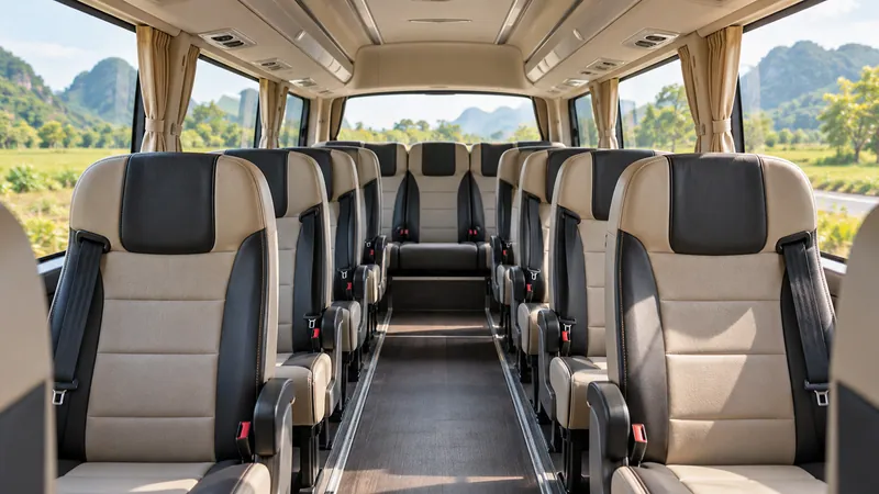 Empty tour minibus seating arranged along a central aisle